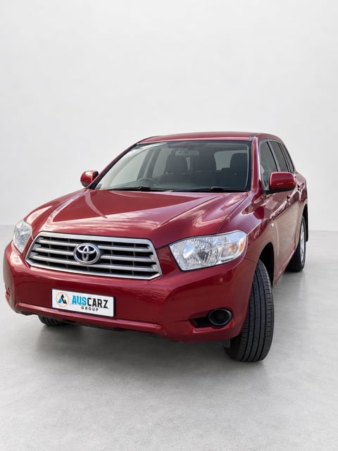 Red Toyota Kluger SUV front view with AUSCARZ license plate on white background