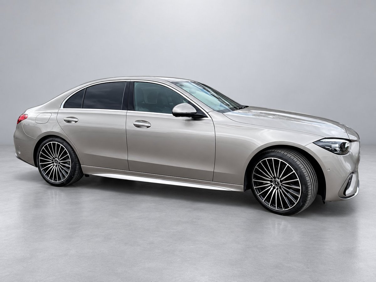 Silver luxury sedan with distinctive grille design and multi-spoke alloy wheels, photographed against a neutral gray background