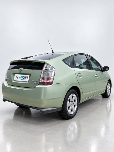 Light green Toyota Prius hybrid car shown from rear three-quarter angle on white background