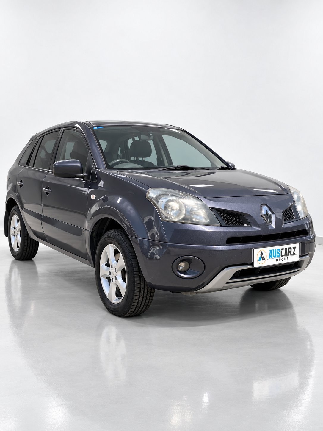 Dark blue Renault Koleos SUV displayed against a white background, three-quarter front view