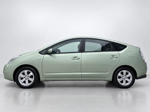 Light green Toyota Prius hybrid sedan shown in profile against a gray background
