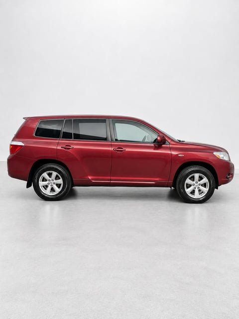 Red Toyota Kluger SUV photographed from the side on a white background