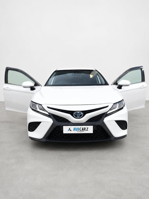 White Toyota Camry front view with both doors open against gray background