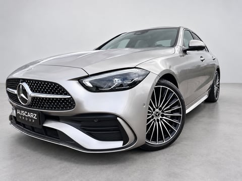 Silver Mercedes-Benz sedan with sleek front grille and alloy wheels displayed in studio setting
