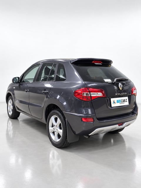 Black Renault Koleos SUV photographed from rear three-quarter angle on white background